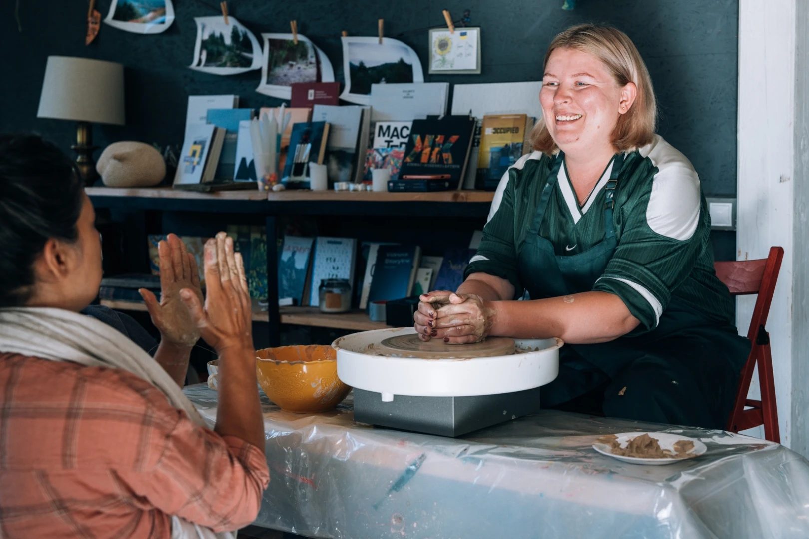 A participant smiling at the pottery wheel