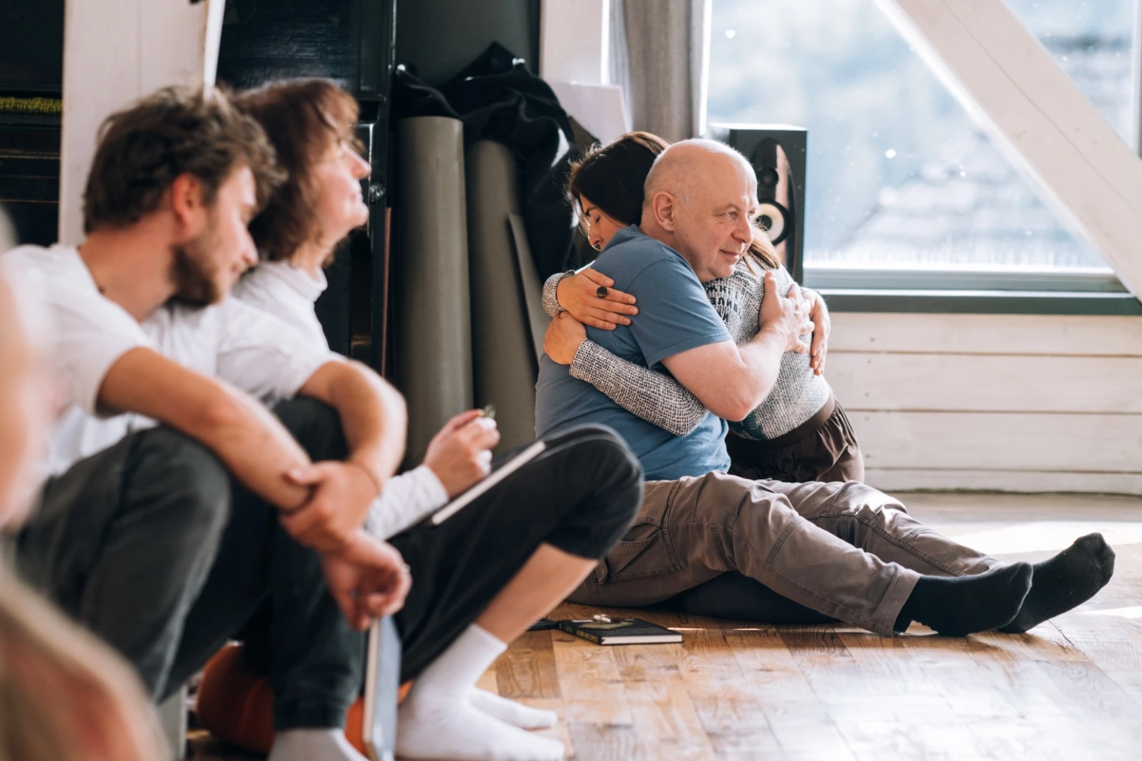 Participants sharing an embrace during a group gathering
