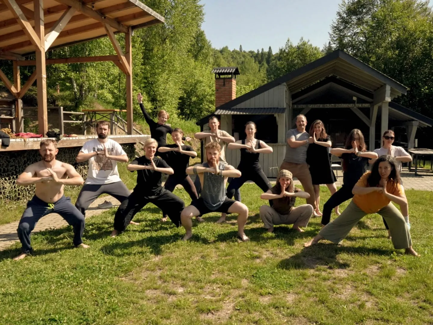 A group practicing Qigong together on the lawn outdoors